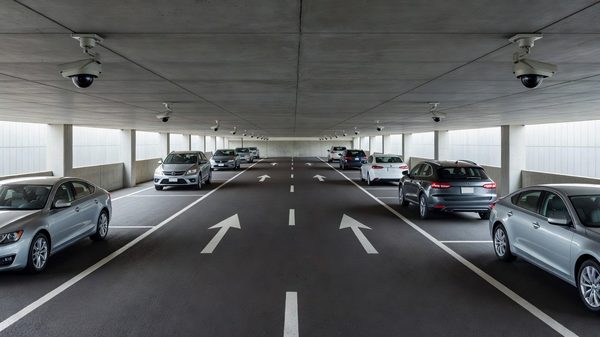 Parking facility entrance lane without gate arm showing open access with overhead cameras